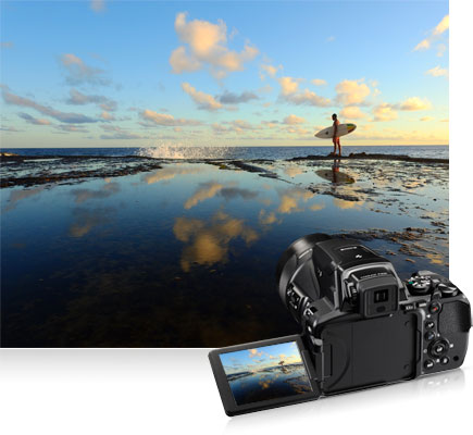 Shoot high or low with a Vari-angle LCD COOLPIX P900 photo of a surfer at the shore and the image on the camera's LCD inset
