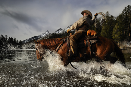 Capture amazing moments, learn how at Nikon School Dave Black photo of a cowboy on horseback in a river