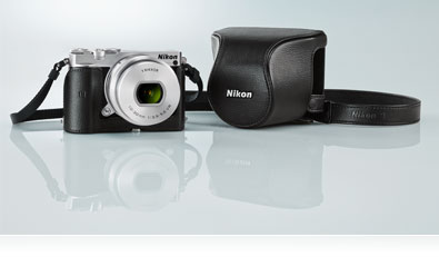 Photo of the silver Nikon 1 J5, lens and black case