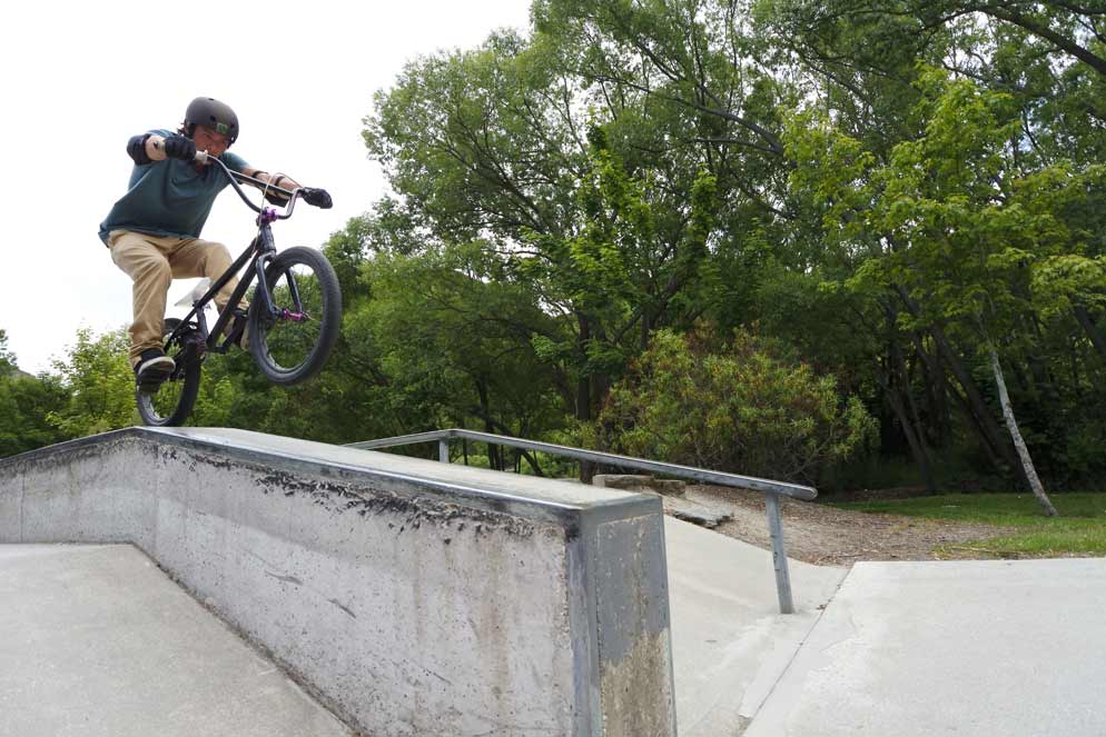 Nikon 1 J5 20 frames per second continuous shooting photo of a boy riding a bike on a railing doing stunts