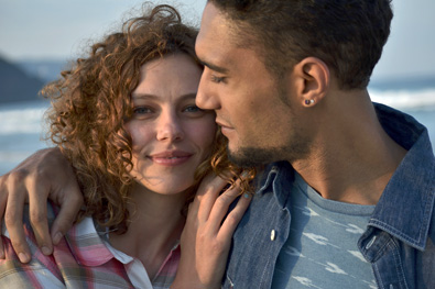 Photo of a woman and man close up at the beach