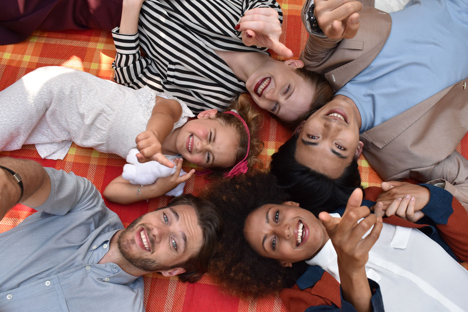 Nikon D5600 DSLR photo of a group of people lying on the floor looking up at the camera