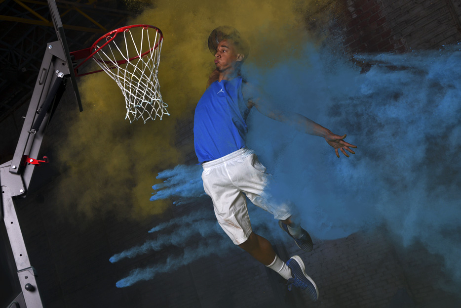 D850 DSLR photo of a basketball player dunking the ball 