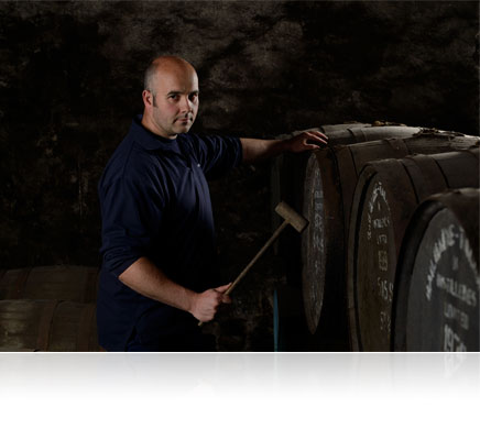Low light photo of a man with barrels of alcohol shot with the Nikon Df