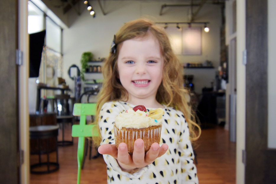 Photo of a girl holding a cupcake, shot with the AF-P DX NIKKOR 10-20mm f/4.5-5.6G VR lens
