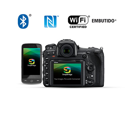 Conecte suas imagens com o mundo Fotografia da parte traseira da D500 e um smartphone com o logotipo do aplicativo SnapBridge na tela LCD, junto com os logotipos de Wi-Fi, NFC e Bluetooth