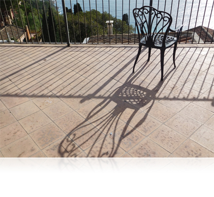 COOLPIX S7000 photo of a chair, fence and their shadows on a tiled terrace
