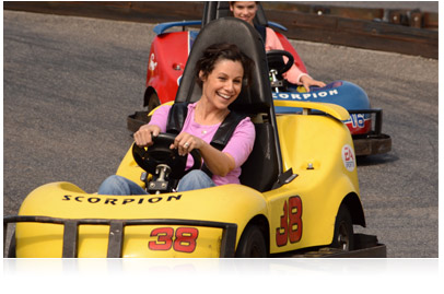 Photo of girl in yellow go-cart with girl in red go-cart following, taken with Nikon D3200 HD-SLR