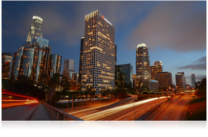 Photo taken with Nikon D3200 HD-SLR, of cityscape taken at night with car headlights and taillights blurred