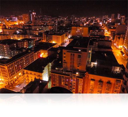 Low light photo of the roofs of buildings in a city