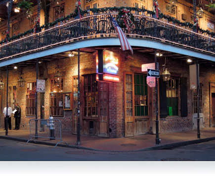 Nighttime photo of a corner building in New Orleans, Louisiana