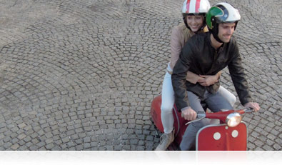 Fast-action photo of a couple riding a motor scooter in New Orleans, Louisiana
