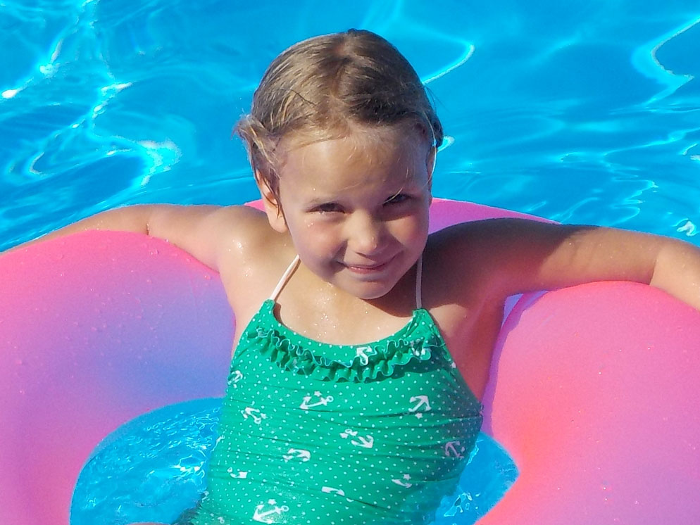 Tight shot of a girl on a floating ring in a pool showing the zoom range of the S32