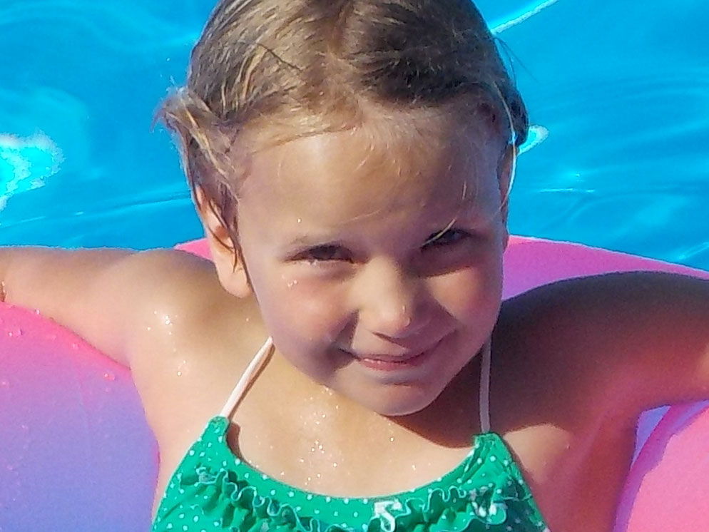 Close up shot of a girl on a floating ring in a pool showing the zoom range of the S32