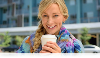 D5300 photo of a woman holding a coffee cup outdoors