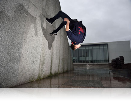 Nikon D750 photo of a male parkour athlete upside down in air, lit with the Nikon SB-500 Speedlight