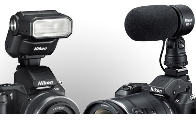 composite photo of the Nikon 1 V2 with accessories: SB-N7 Speedlight, GP-N100 GPS unit and ME-1 stereo mic