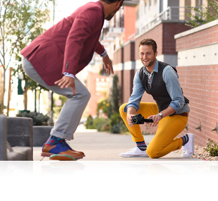 Vari-angle LCD lets you be more creative D5500 photo of a man kneeling on the ground photographing another man on a skateboard, using the Vari-angle LCD