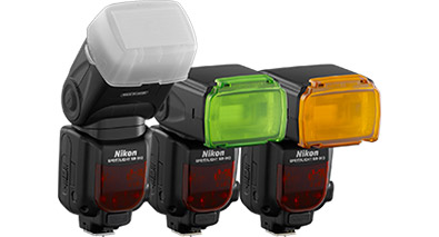 Learn about Speedlights and their accessories Photo of 3 Nikon Speedlight flashes, with color correction filters and a diffuser on them