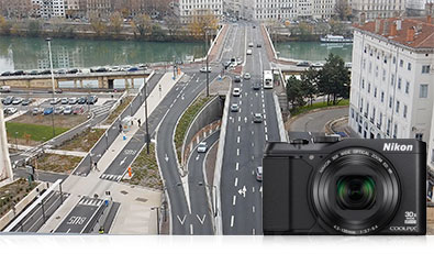 Photo of a city's roads from the air, inset with a photo of the S9900 camera