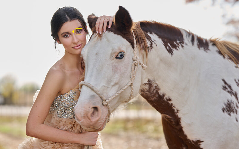 photo of a woman standing next to a horse, taken with the NIKKOR Z 85mm f/1.2 S lens
