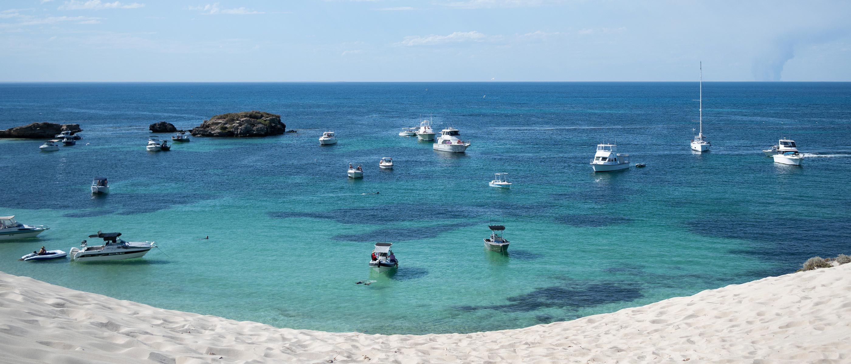 photo of a shoreline with boats on the shallow water, taken with the NIKKOR Z DX 24mm f/1.7