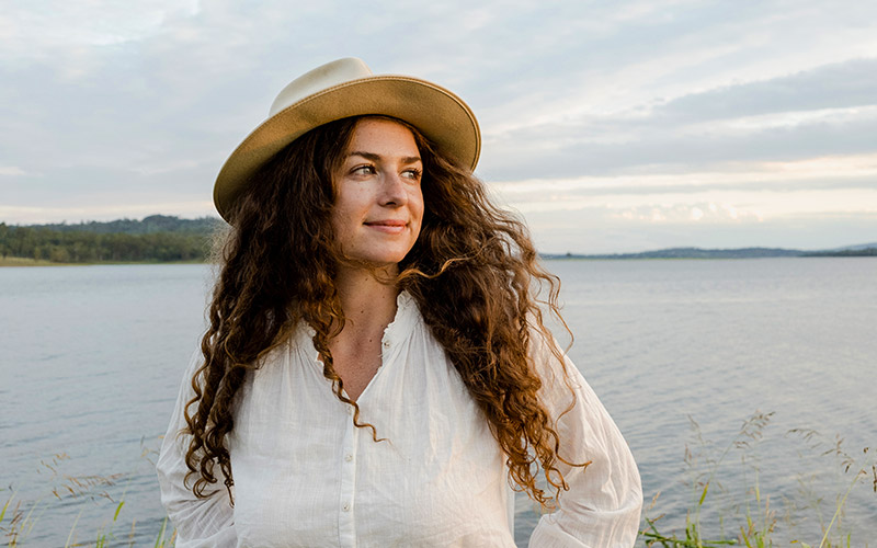 photo of a woman with a lake in the background, taken with the NIKKOR Z DX 12-28mm f/3.5-5.6 PZ VR lens