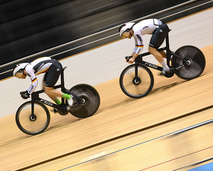 photo of 2 bicyclists on a velodrome track, taken with the NIKKOR Z 400mm f/2.8 TC VR S lens while panning