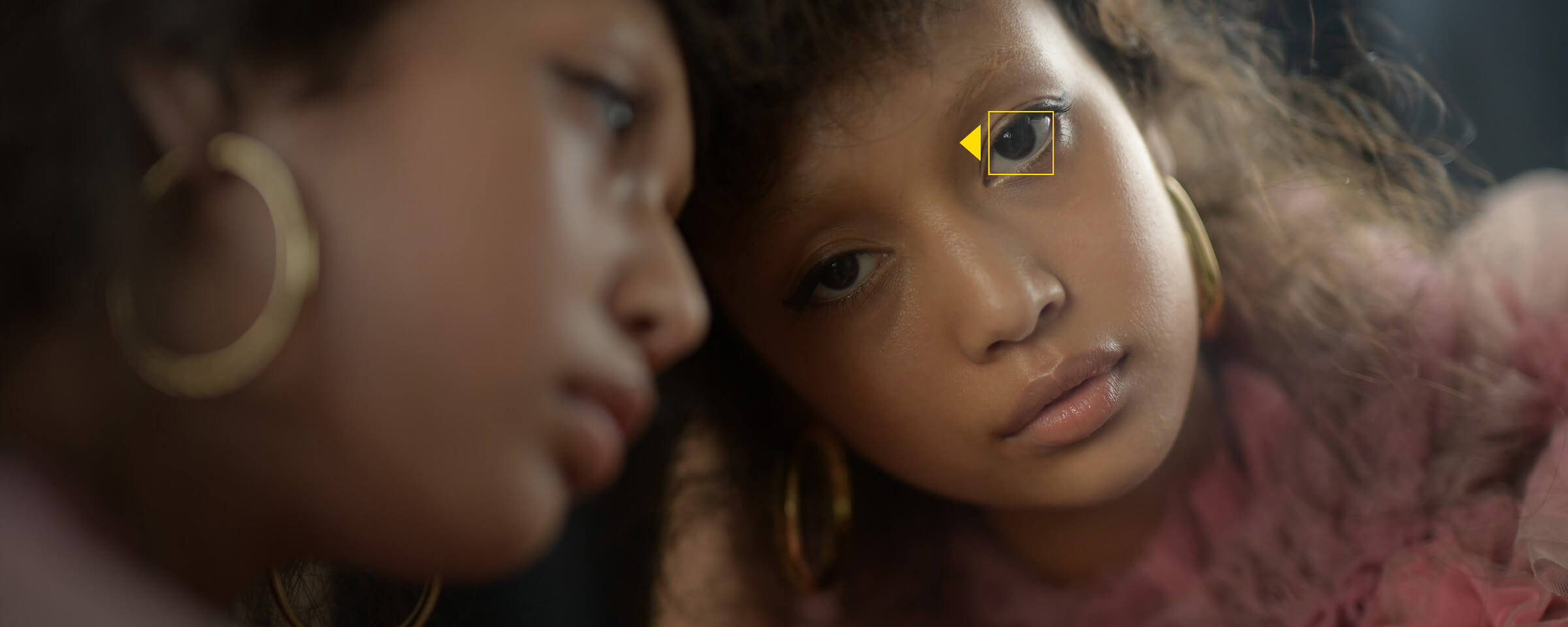 Photo of two female models, and the Eye-Detect AF icon. Photo taken with the NIKKOR Z 50mm f/1.2 S lens