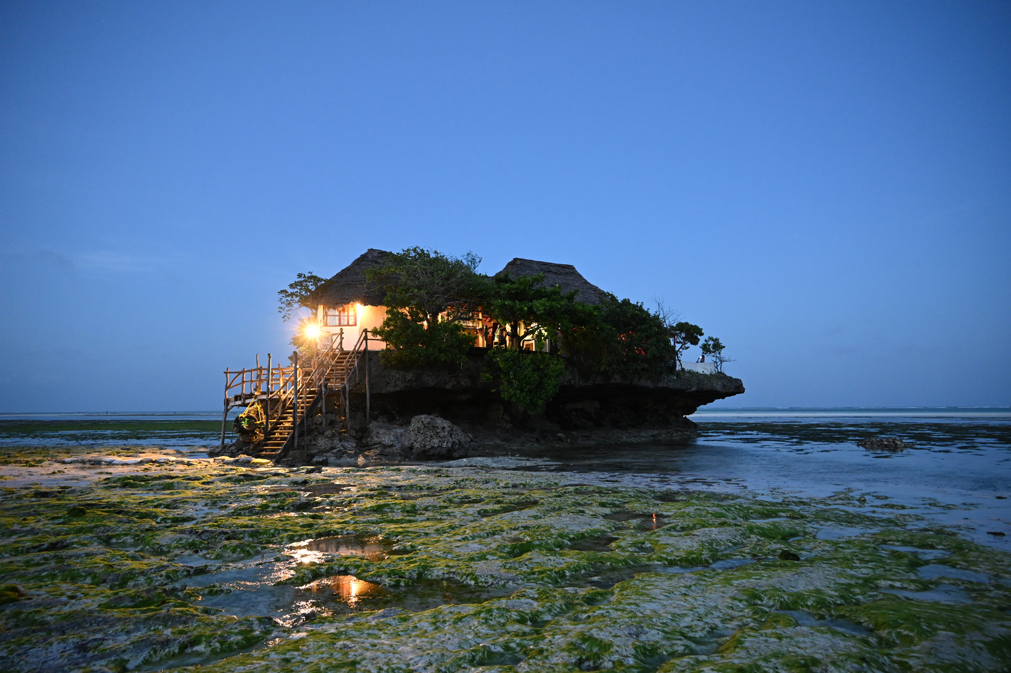 Low light photo of a house built on rocks at the shore, taken with NIKKOR Z 24-200mm f/4-6.3 VR