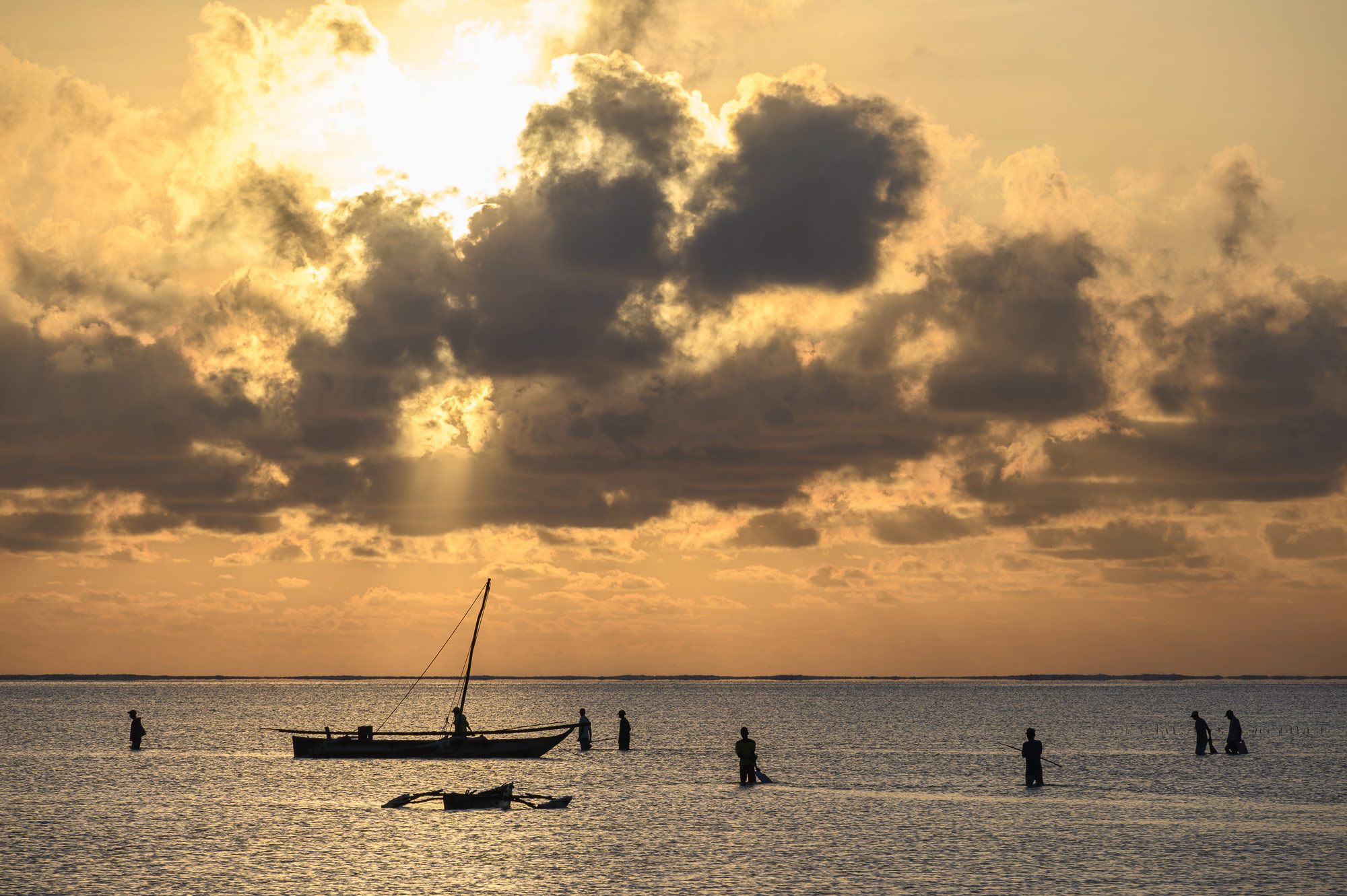 low light photo of people fishing at the shore, at sunset, taken with the NIKKOR Z 24-200mm f/4-6.3 VR