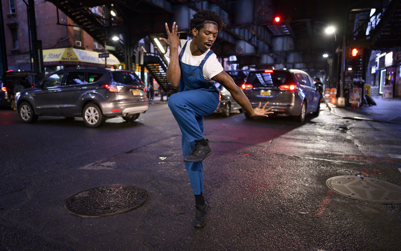 Image of man dancing at night on the street, taken with the NIKKOR Z 24mm f/1.8 S lens