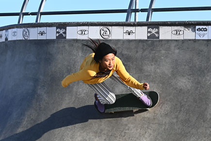 Z 50 and NIKKOR Z DX 50-250mm f/4.5-6.3 VR photo of a person skateboarding on the wall of a pool