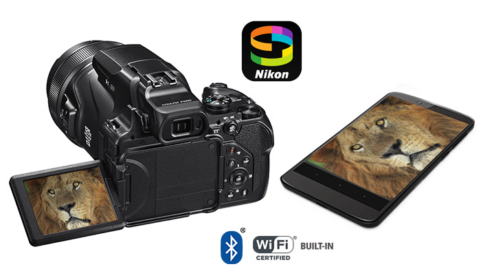 COOLPIX P1000 fotoÄraf makinesinin ve LCD ekranÄ±n ve aslanÄ±n yÃ¼zÃ¼ndeki aslanÄ±n fotoÄrafÄ±nÄ±n bulunduÄu bir akÄ±llÄ± telefonun ve SnapBridge logosunun fotoÄrafÄ±