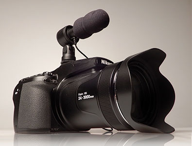 Photo of the COOLPIX P1000 with the ME-1 stereo microphone on the hot-shoe