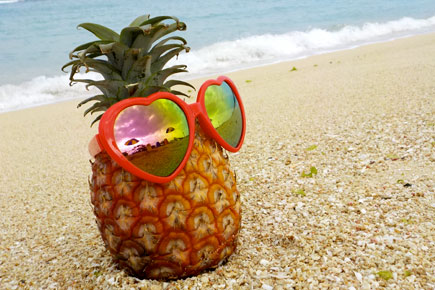 COOLPIX W150 photo of a pineapple wearing sunglasses on the beach
