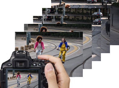 Photo of a Nikon D5600 DSLR with an image of two women bike riding on the LCD and a group of shots showing fast FPS shooting