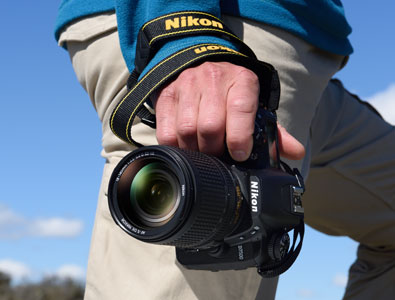 Photo of a person's torso with the camera in hand