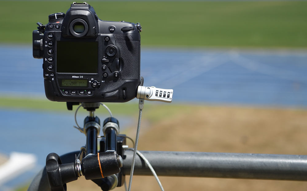 Photo of the D6 DSLR chained to a railing using the Kensington Anti-Theft lock