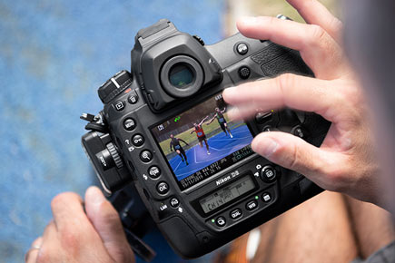Photo of a photographer using the touch LCD of the D6 DSLR