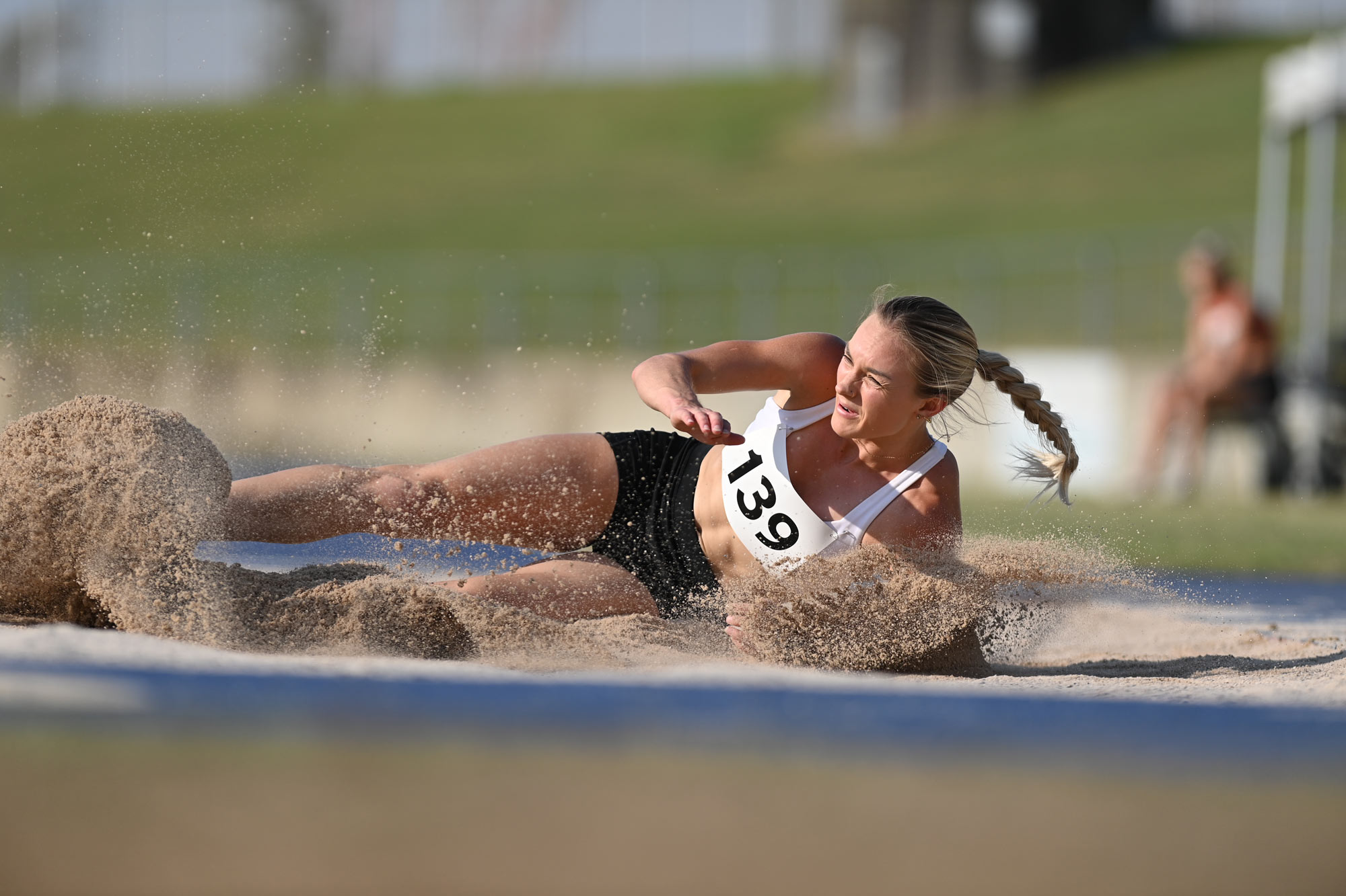 D6 DSLR photo of a track athlete in the sand of the long jump