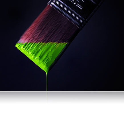 Photo of a paintbrush with bright green paint dripping off the edge, lit with Nikon Speedlights