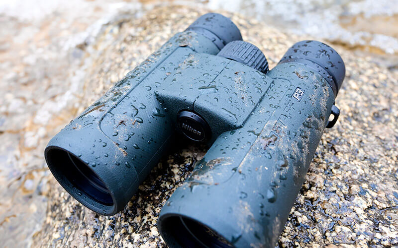 Photo of PROSTAFF P3 binoculars on a rock with water drops