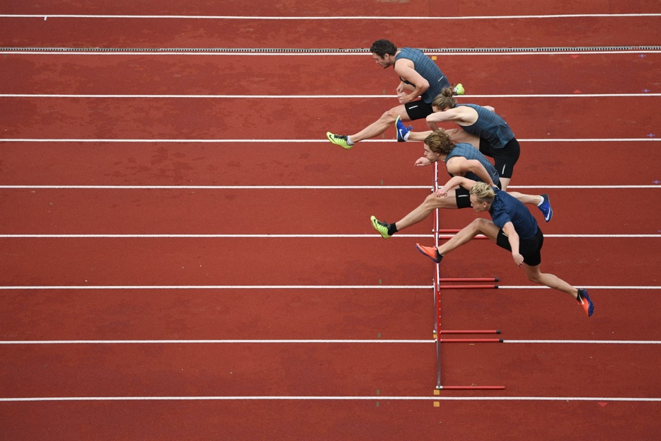 Draw peak performance with select Nikon DSLRs Joel Marklund photo of four hurdlers on a track, taken with the AF-S NIKKOR 180-400mm f/4E TC1.4 FL ED VR lens