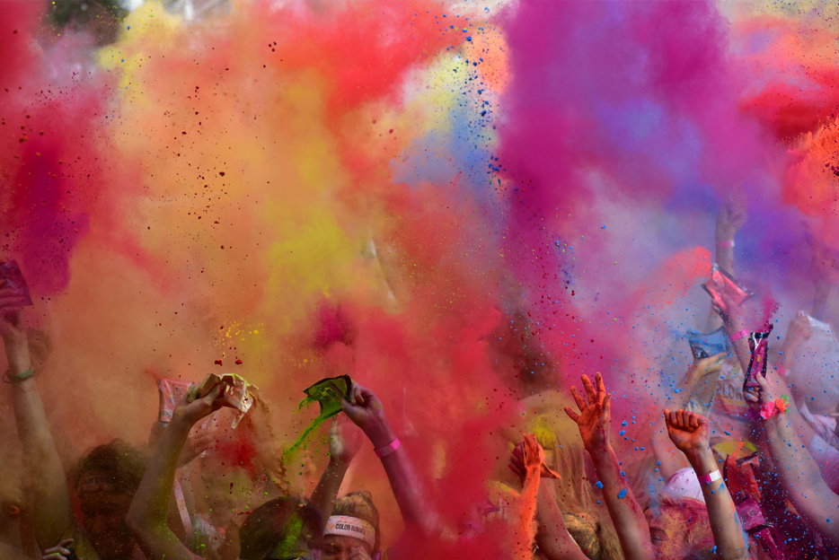 Photo of a cloud of paint dust in the air above cheering hands, taken with the AF-P DX NIKKOR 70-300mm f/4.5-6.3G ED VR lens