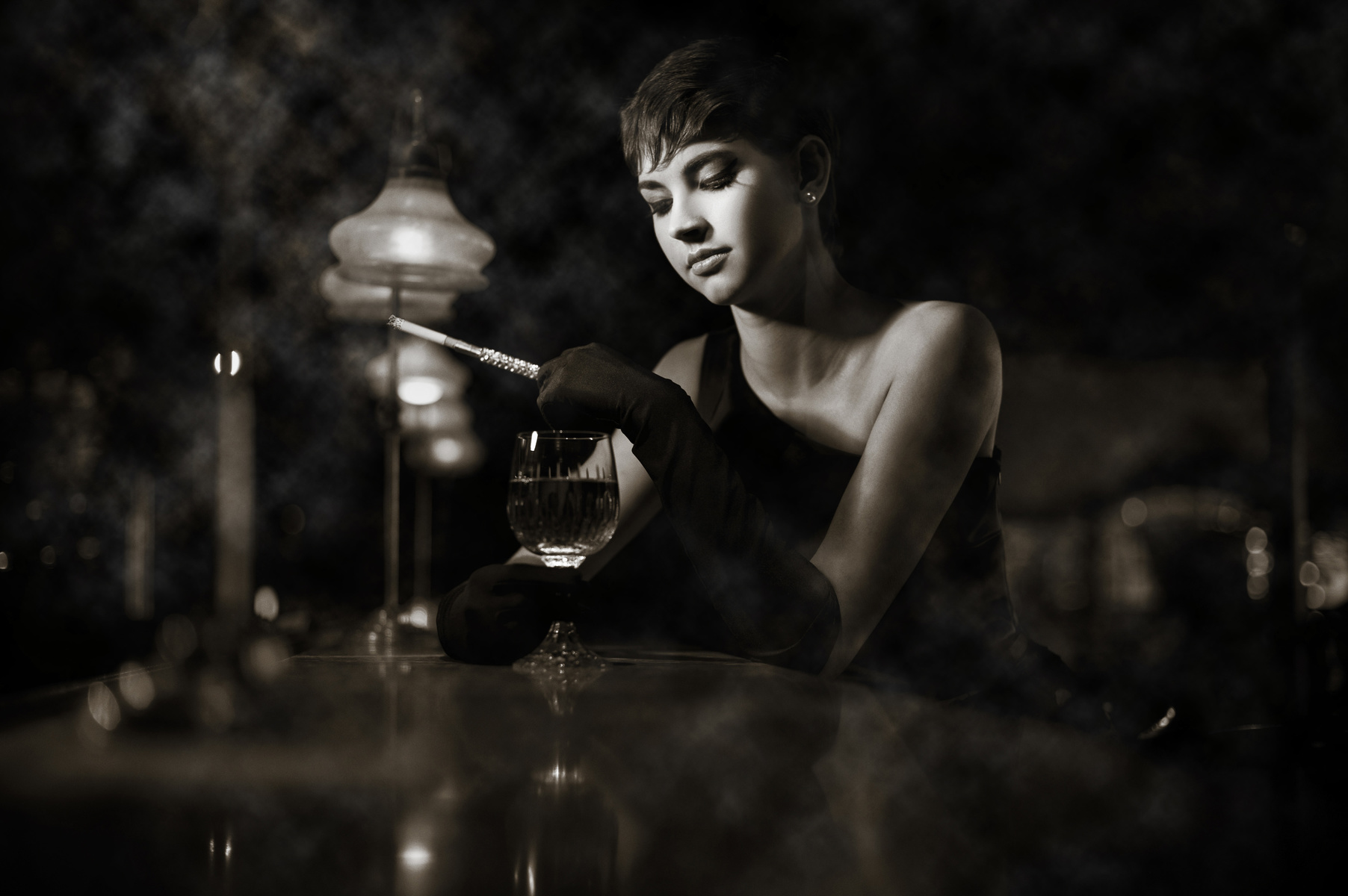 Photo of a woman sitting at a bar, low key, sepia tone, shot with the AF-S NIKKOR 50mm f/1.4G lens