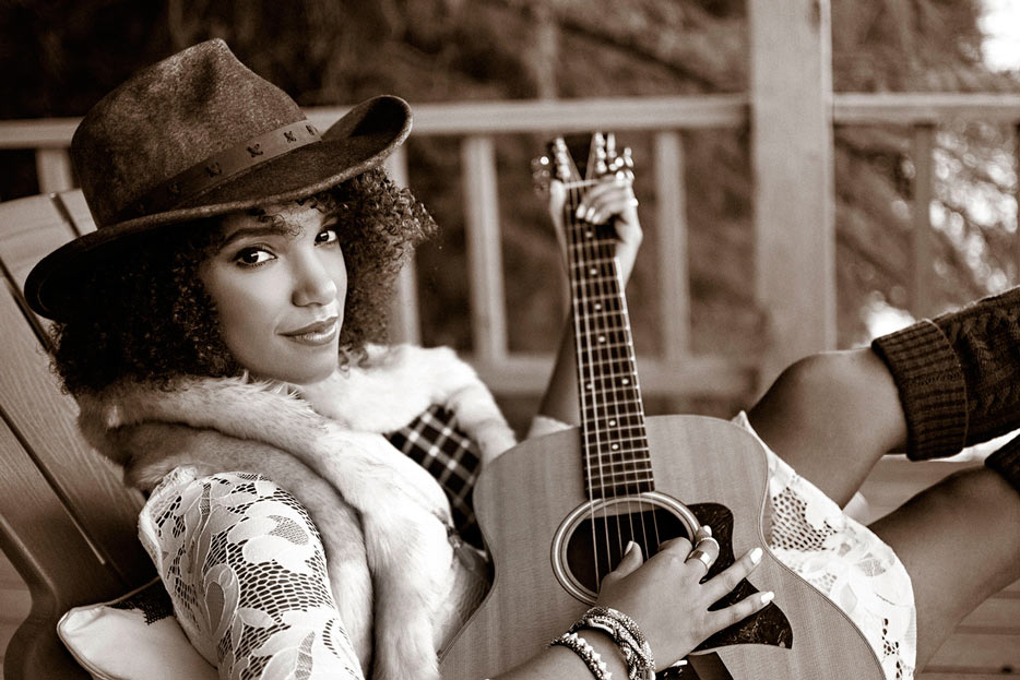 AF-S DX NIKKOR 35mm F/1.8G photo of a woman playing a guitar, in sepia tone