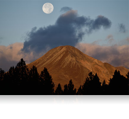 Photo of a mountain with the full moon in the sky shot using the AF-S NIKKOR 300mm f/4E PF ED VR lens