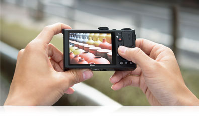 Photo of a person's hands holding the P340 with an image on the LCD